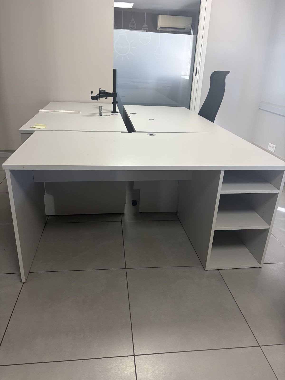 Bureau professionnel finition gris, avec rangement intégré sur le côté.